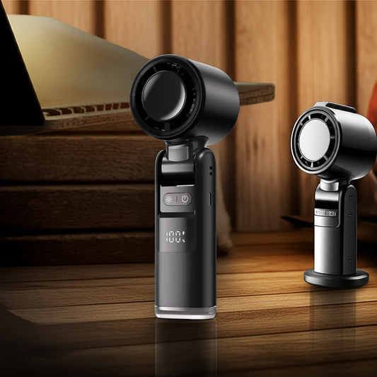 Compact USB mini turbo cooling fan with digital display on wooden desk near laptop and chair.